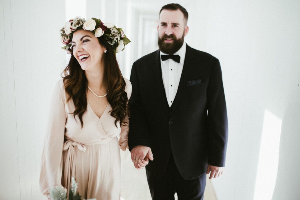 bride and groom laugh and hold hands at the Fogo Island Inn during their elopement