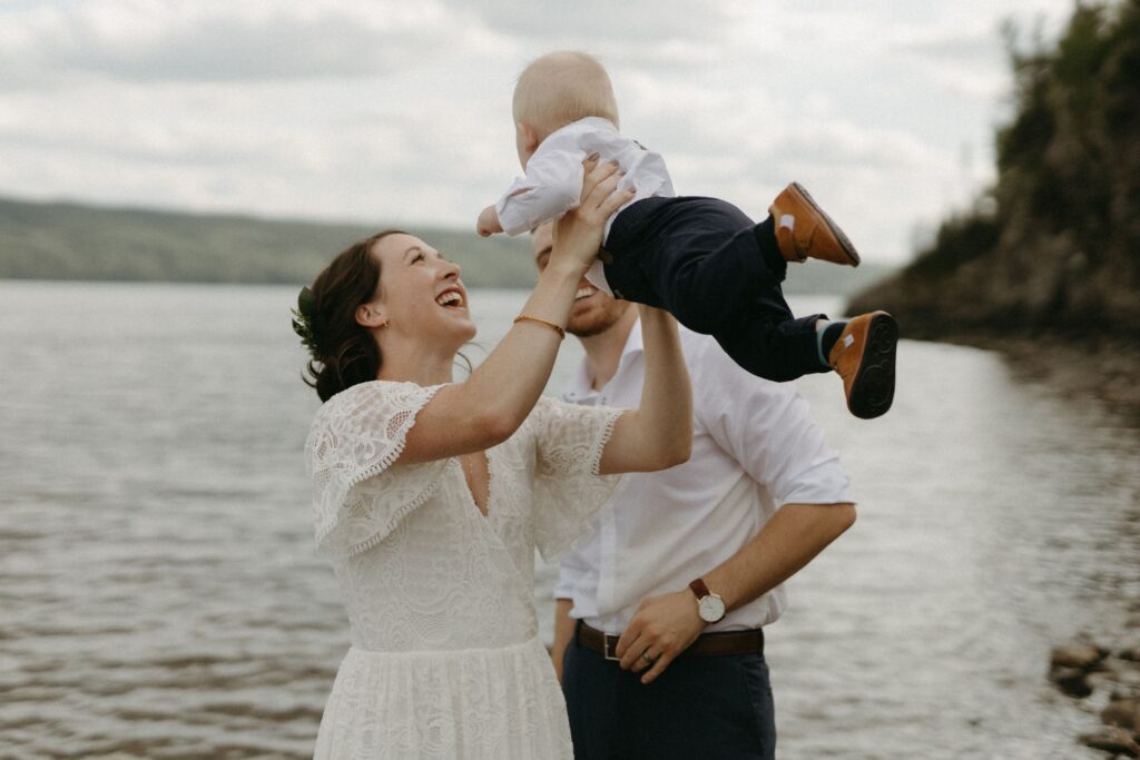 bride and groom play with baby during BC elopement