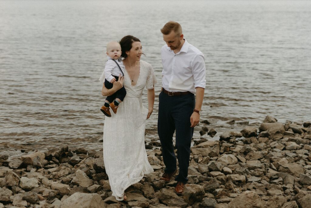 bride, groom and baby walk up the beach during BC elopement
