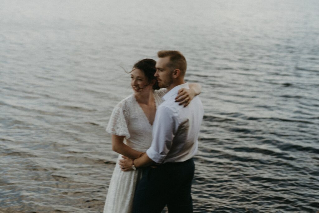 bride and groom look out over the water during their BC elopement