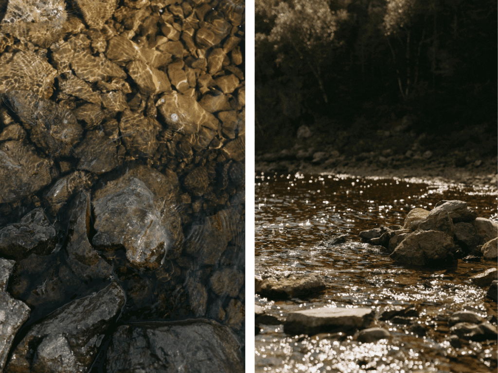 golden sunlight hits the lake's surface, illuminating the rocks below