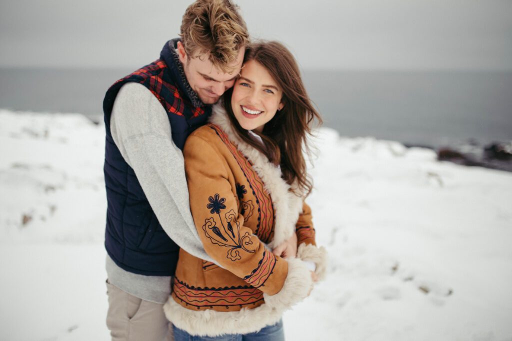 Bride and groom cuddle in the snowy landscapes outside the Fogo Island Inn