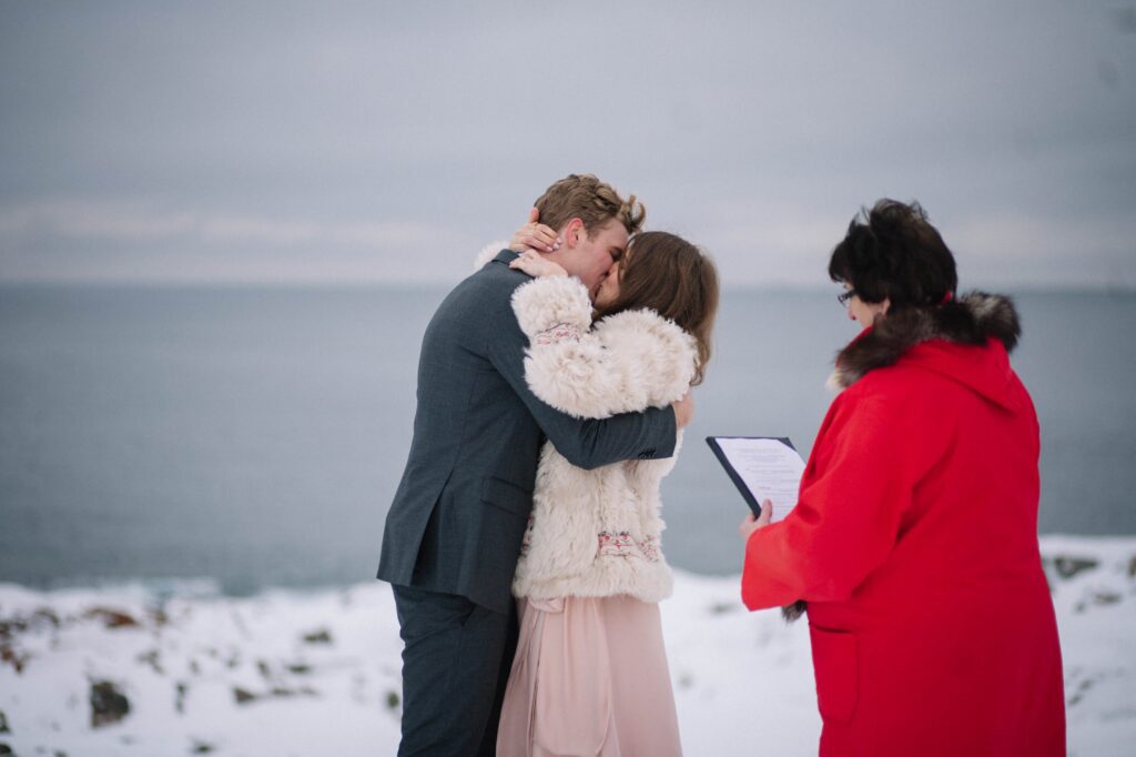 bride and groom kiss during elopement ceremony on fogo Island