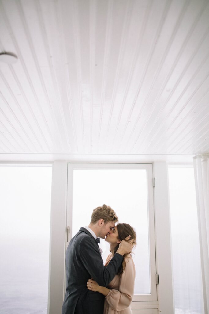 Bride and groom kiss inside the Fogo Island Inn