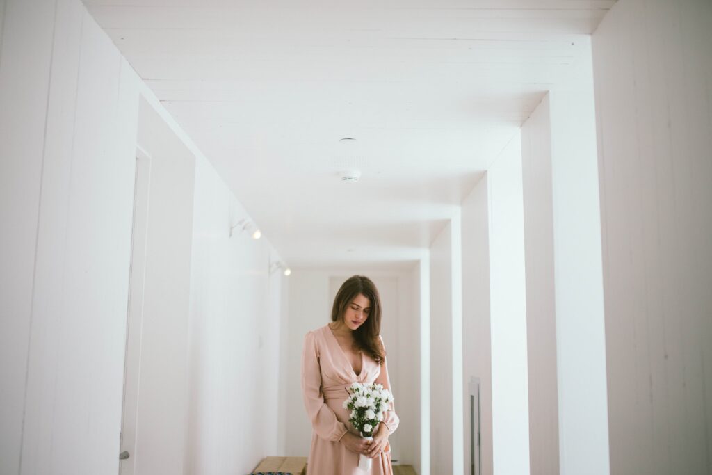 Bride looks at her bouquet at the Fogo Island Inn.