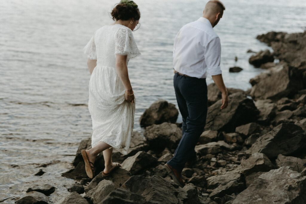 bride and groom explore the shore during Newfoundland elopement