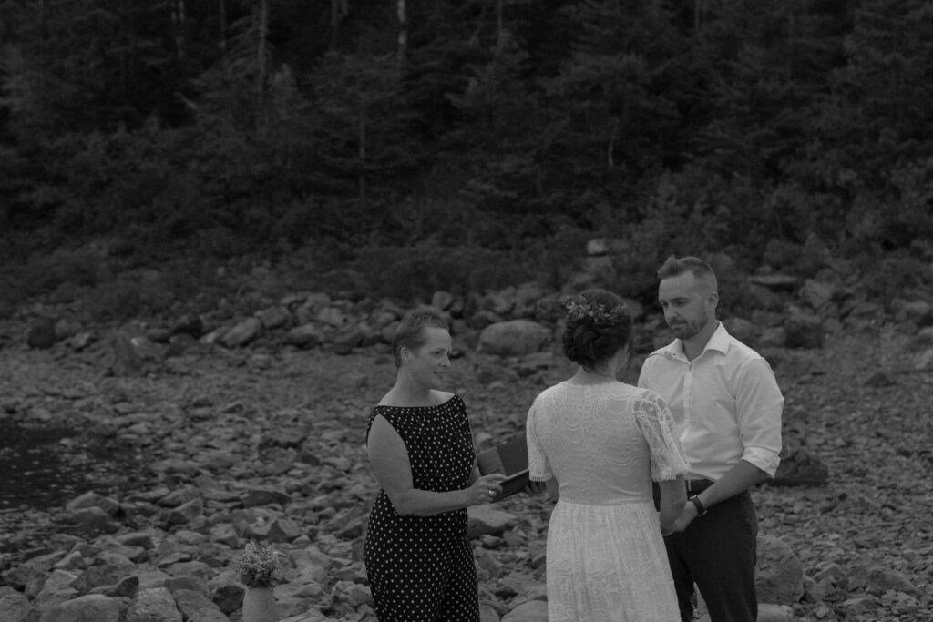 bride and groom hold hands during their elopement ceremony on the beach