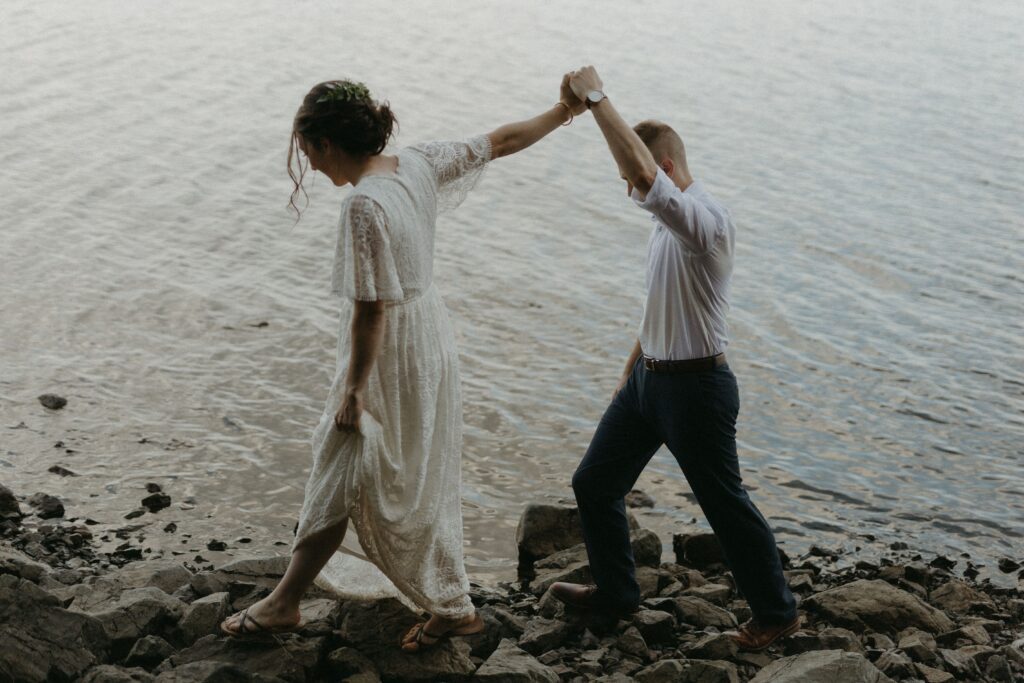 bride and groom explore the rocky shore during their Newfoundland elopement 