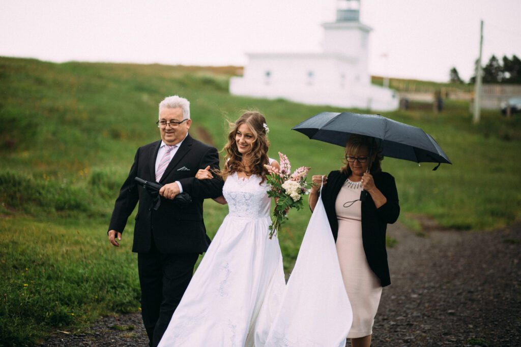 bride walks up the hiking trail with her parents