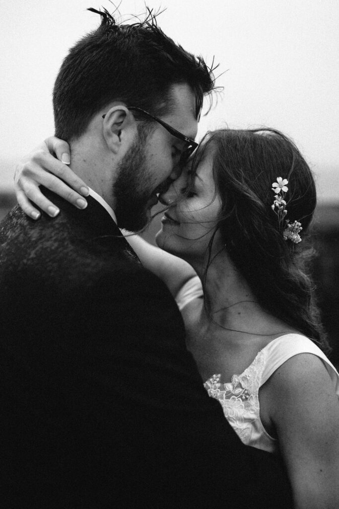 bride and groom hold each other close in the rain during Newfoundland elopement