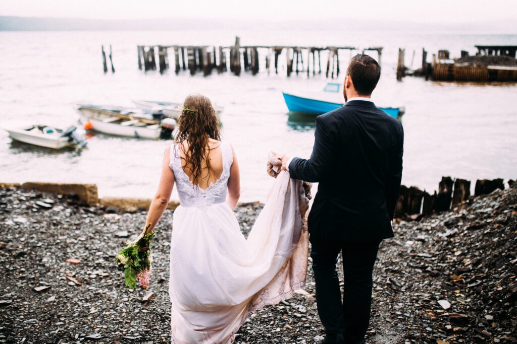 bride and groom explore a small harbour in the pouring rain during their Newfoundland elopement