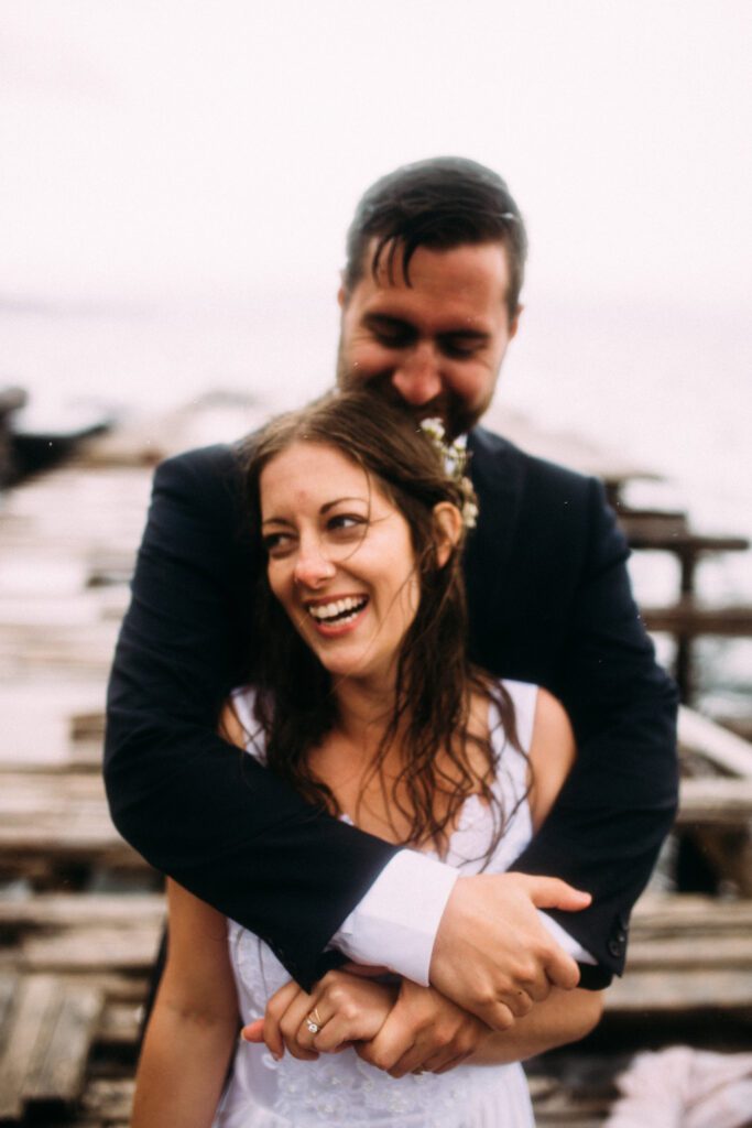 bride and groom hold each other and laugh during their Newfoundland elopement