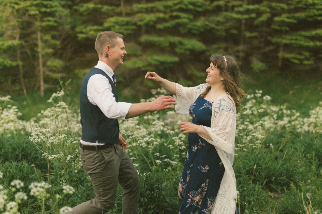 bride and groom laugh and run toward each other during Newfoundland elopement