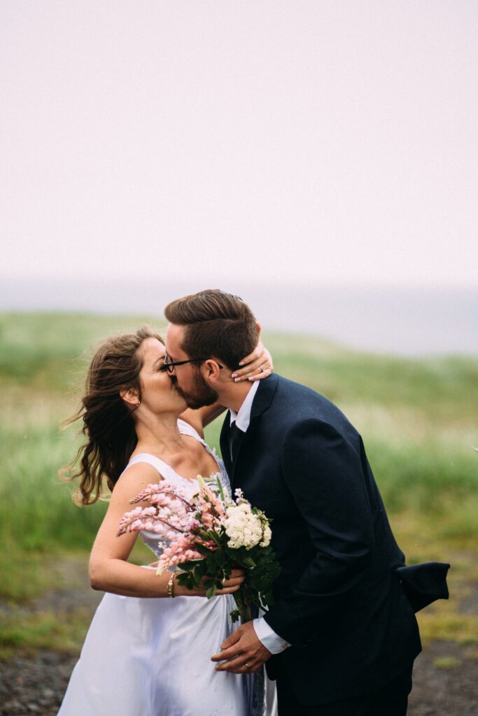 bride and groom kiss during elopement ceremony in Newfoundland