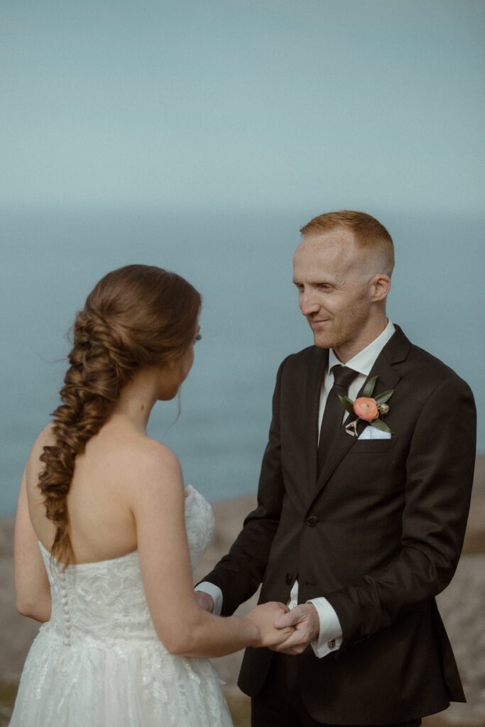 bride and groom hold hands during Newfoundland elopement ceremony