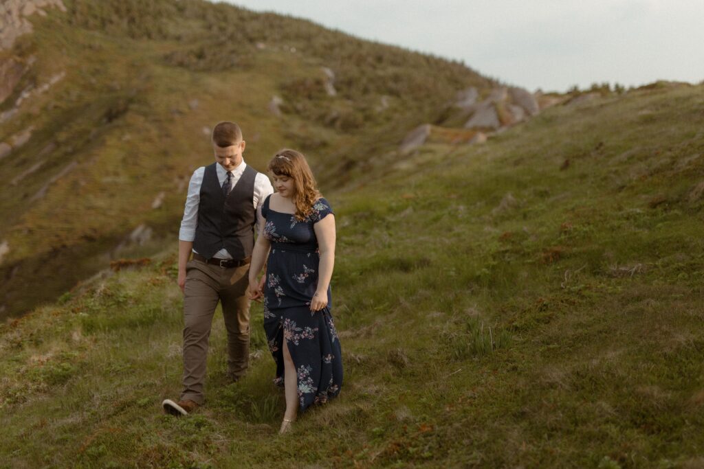 bride and groom explore the cliffs of Newfoundland during hiking elopement