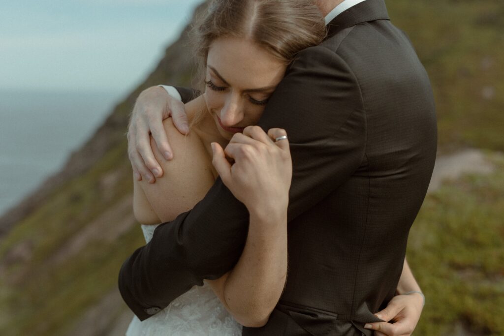 bride and groom hold each other close during Newfoundland elopement ceremony