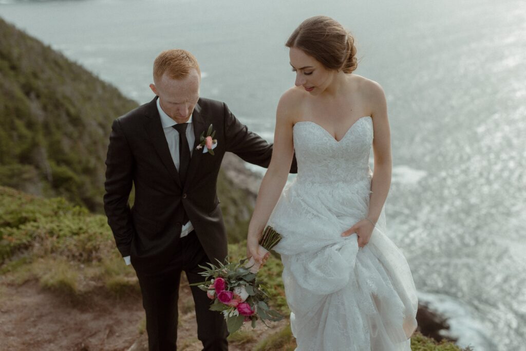 bride and groom explore the cliffs of Newfoundland during their elopement