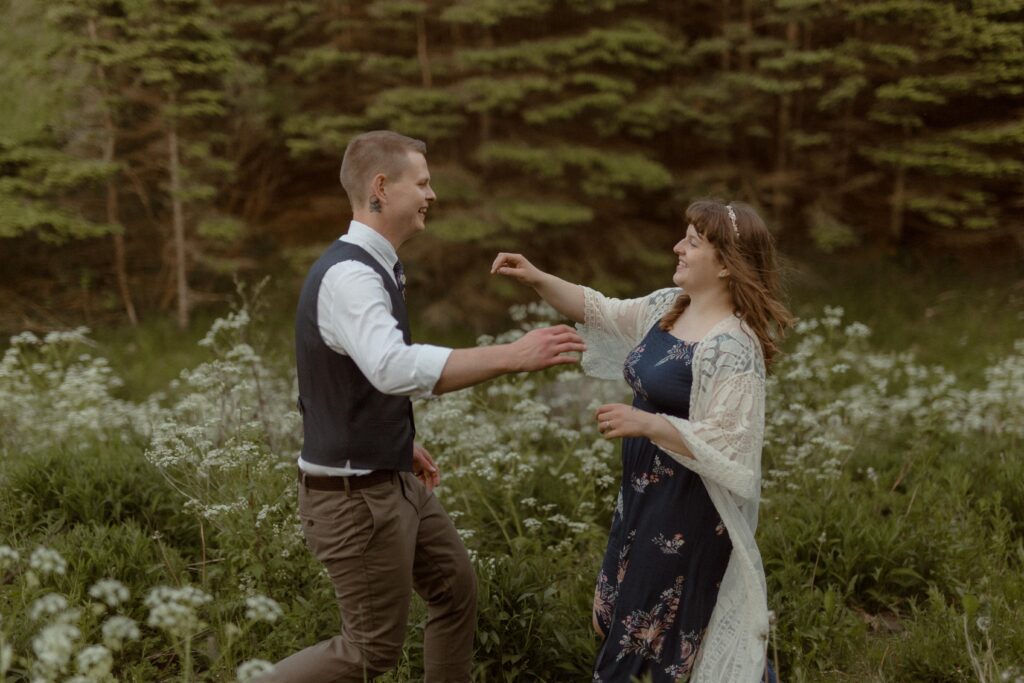 bride and groom laugh and run toward each other during Newfoundland elopement