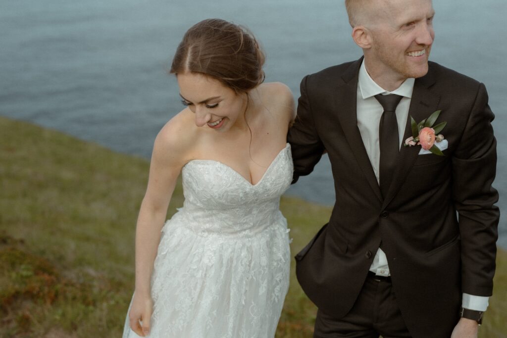 bride and groom explore the cliffs of Newfoundland during their elopement