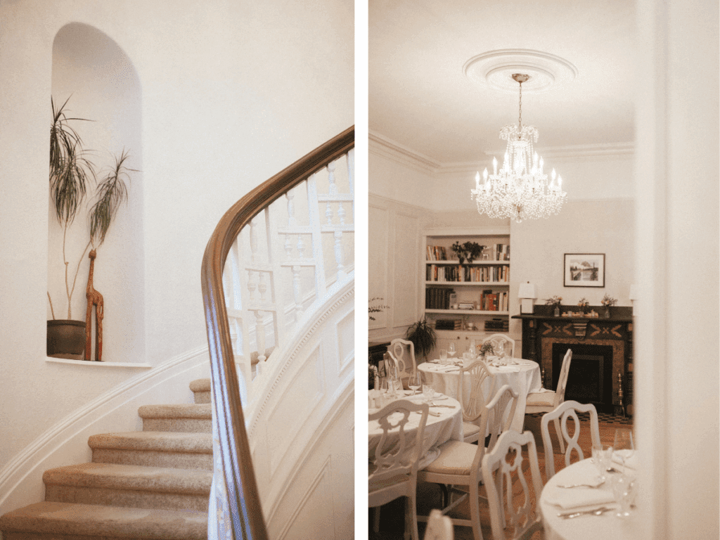 a victorian dining room set for dinner with round white tables and a crystal chandelier