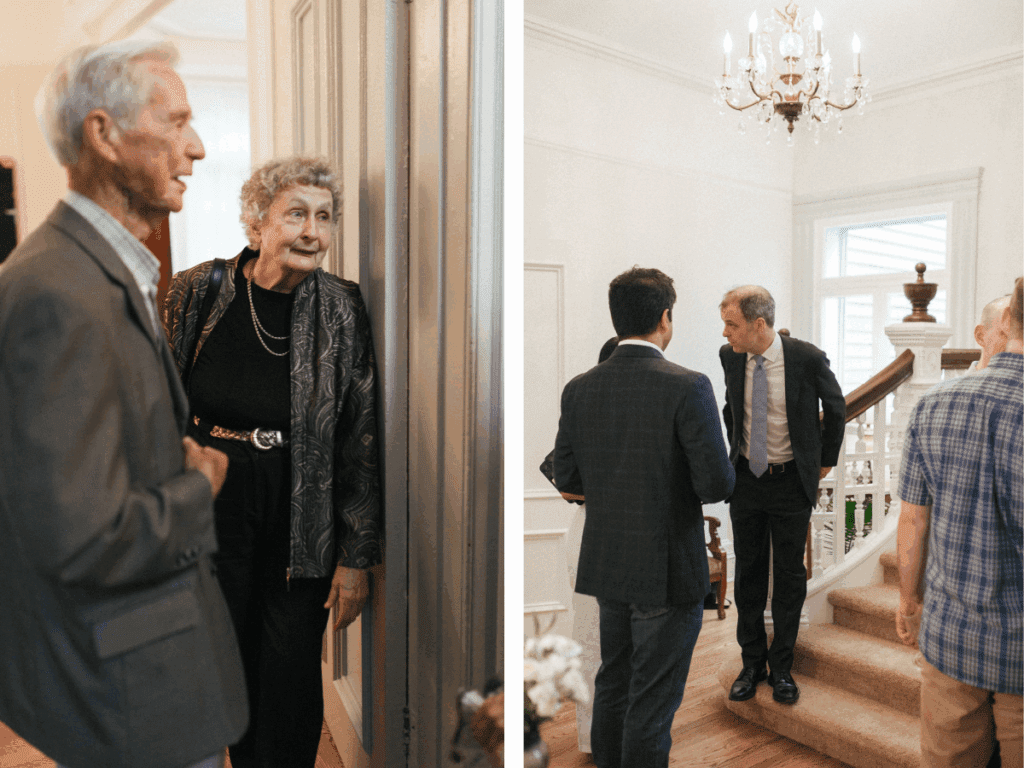 candid photo of bride's grandparents leaning in a door frame and smiling