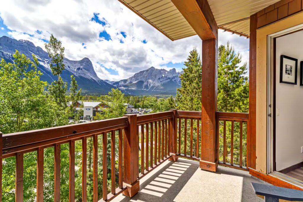 a deck overlooking Canmore, Alberta with mountains in the background
