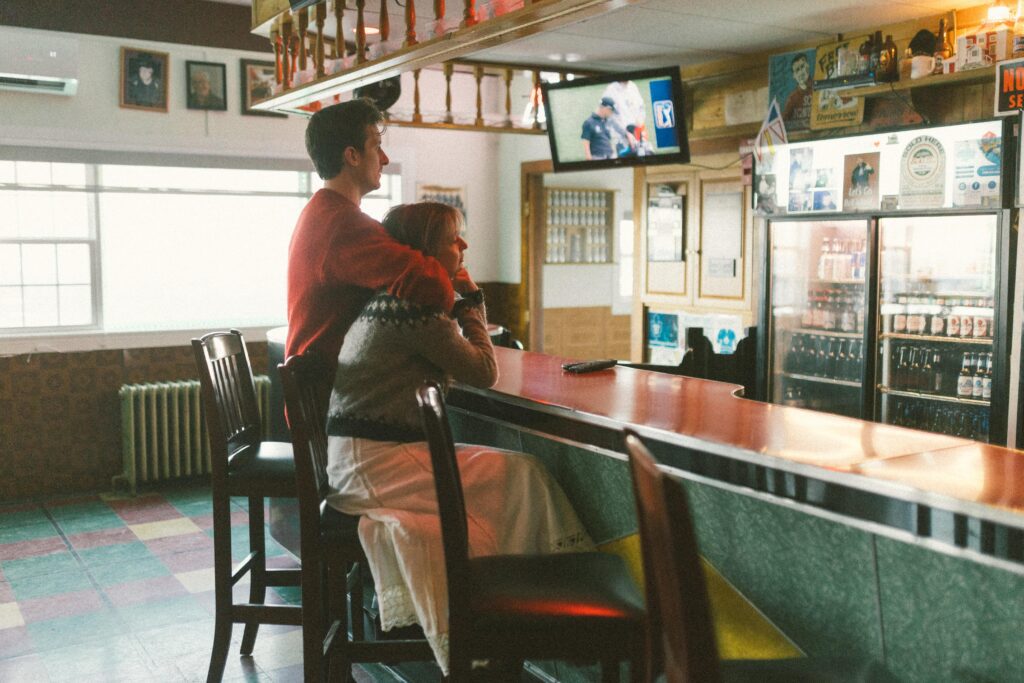 couple wait for a beer at a dive bar