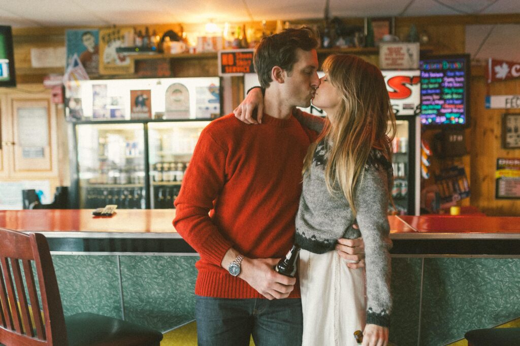 couple kiss at dive bar