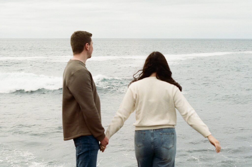 film photo of a couple looking out over the Atlantic Ocean in Newfoundland