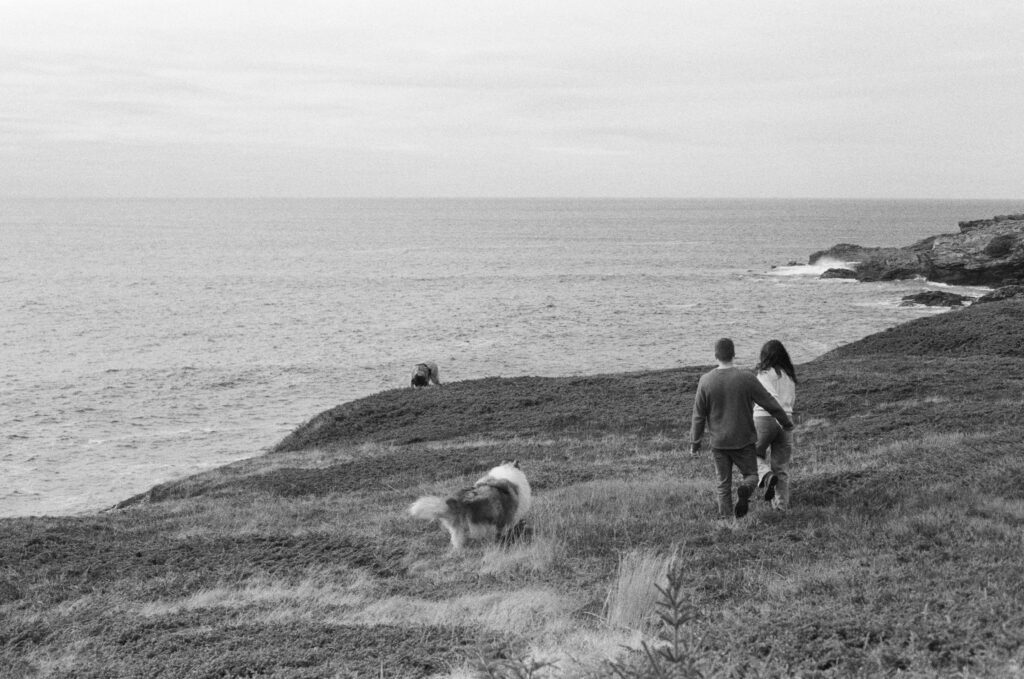 film photo of a couple and their dogs walking a coastal trail in Bonavista