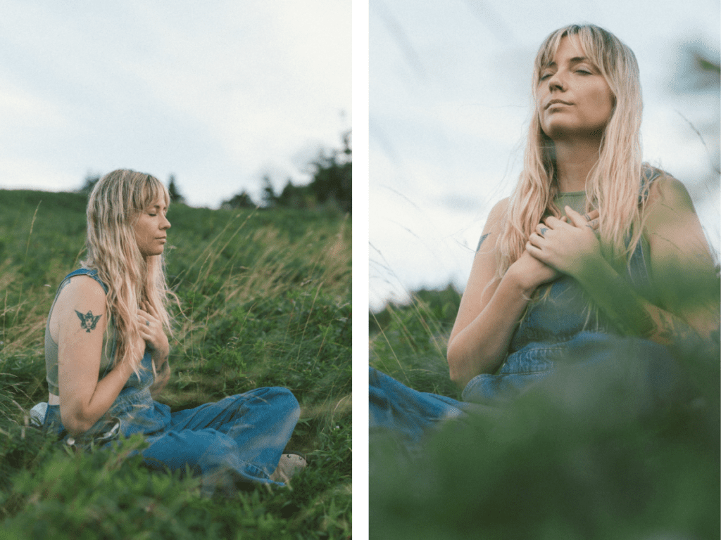 blonde woman with tattoos meditates in a wild meadow during Self Love Session