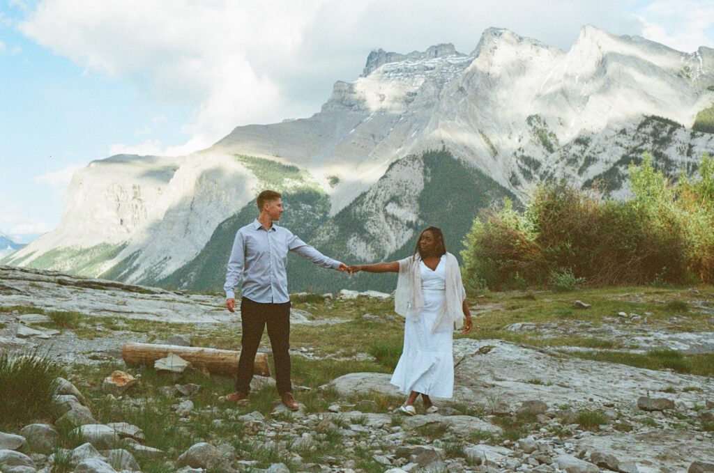 Bride and groom explore Lake Minnewanka together during their Banff elopement