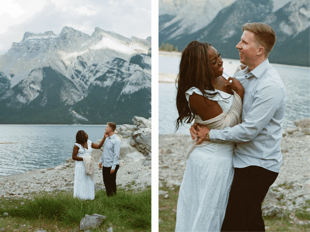 bride and groom laugh and hold each other on the shore of a glacier-blue lake in Banff National Park