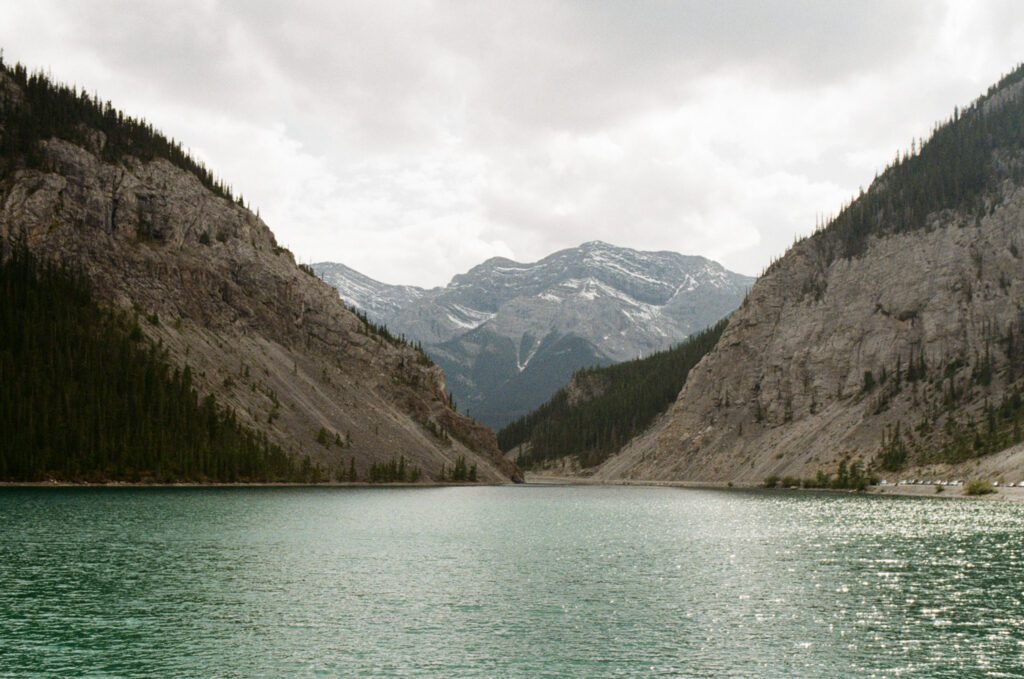 a turquoise glacier-fed lake framed by snow-capped mountains in Canmore, Albera
