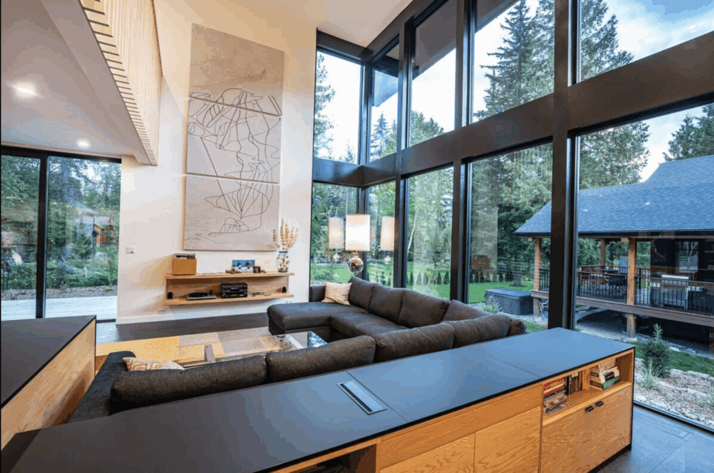 a modern space with high ceilings, floor to ceiling windows, and modern art on the walls