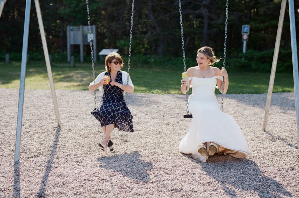 bride swings on the swing set with her grandmother