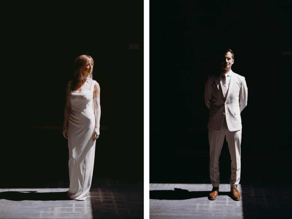 35 mm photo of bride and groom standing in window light with the rest of the room in shadow