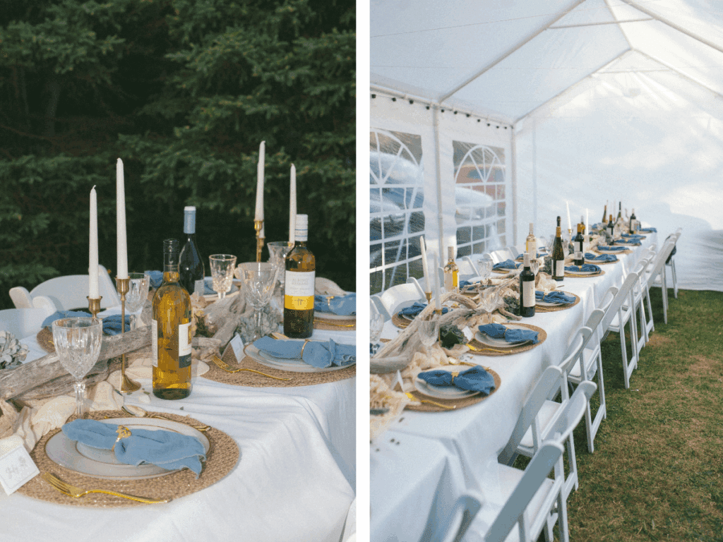 a long table is set beneath a tent with wine, candles, driftwood and beach treasures.