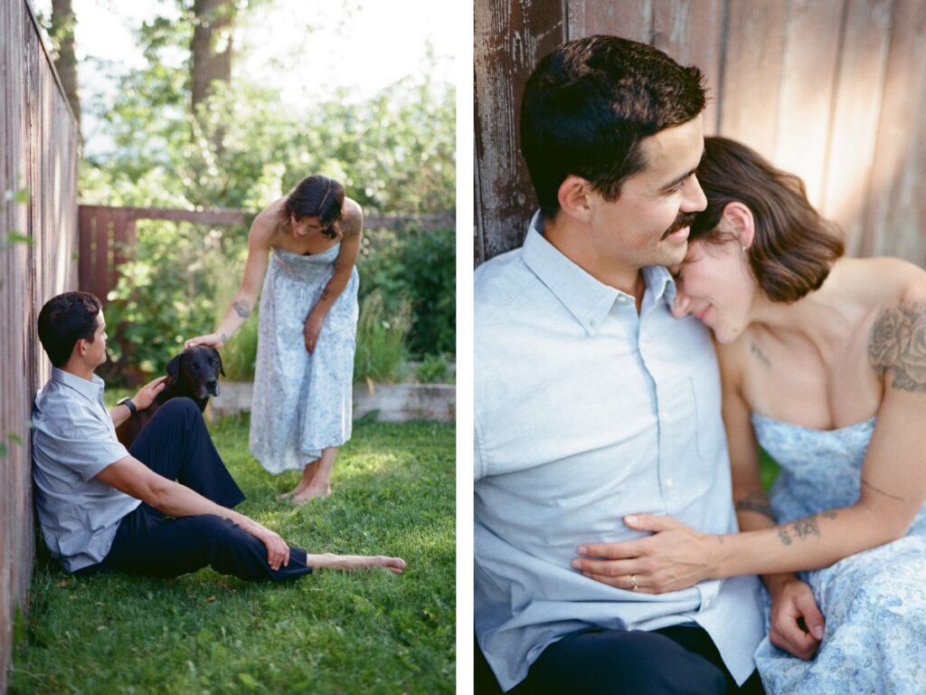man and woman dressed in blue hold each other next to a red fence