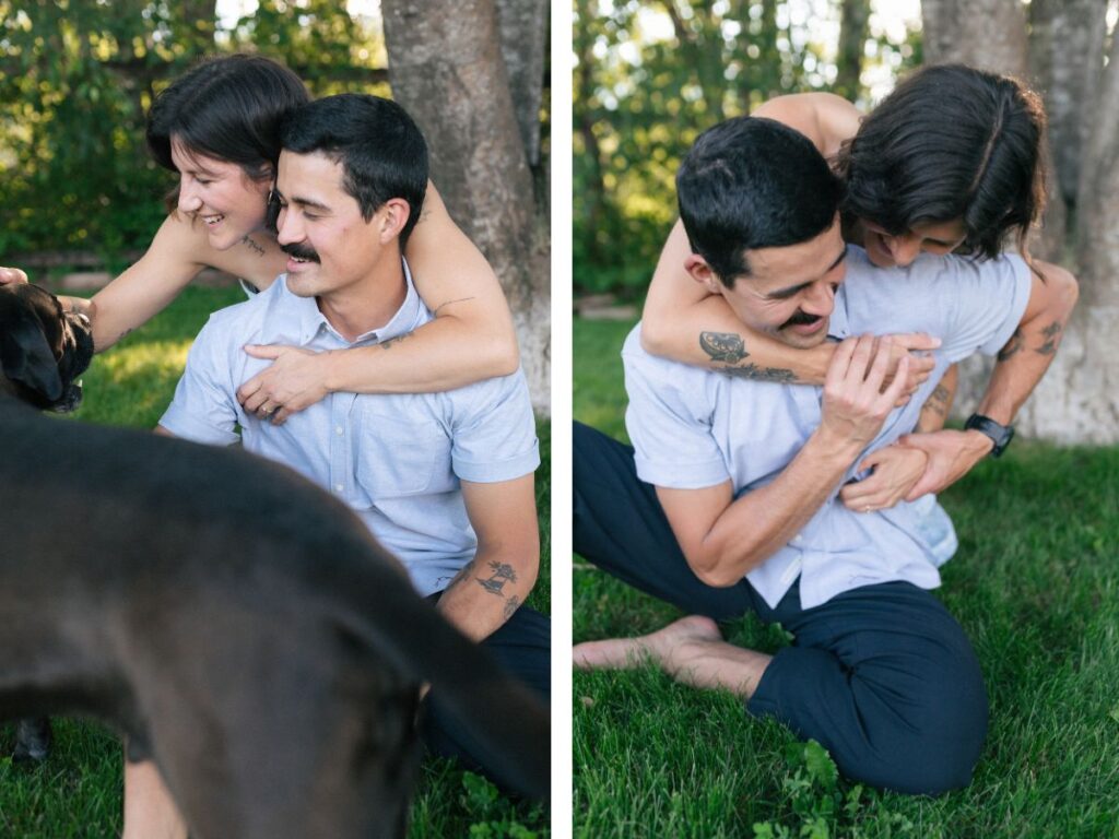 man and woman wrestle playfully in the grass