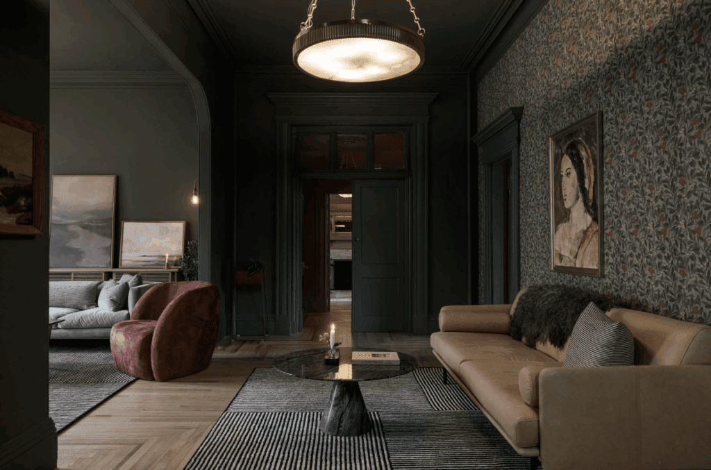 a modern victorian interior with green floral wallpaper and modern furniture