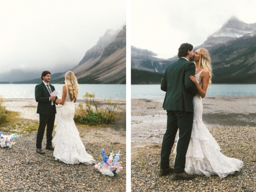 bride and groom share their first kiss on a rocky beach with mountains rising behind them