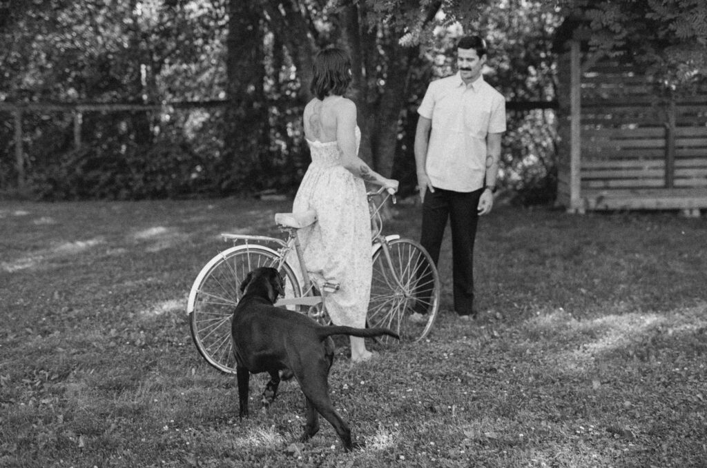 woman stands with a vintage bicycle