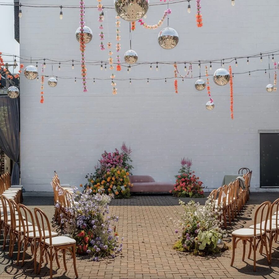 Fort Common in Victoria set up for a vibrant wedding with disco balls and bright florals