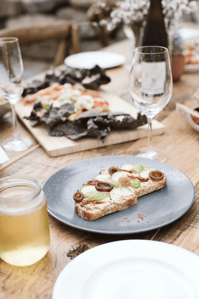 Bespoke meals on a rustic wooden table laid out for a wedding at Bodega Ridge on Galiano Island