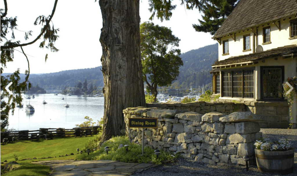 a historic house by the sea with a large lawn space set up for a wedding on Salt Spring Island