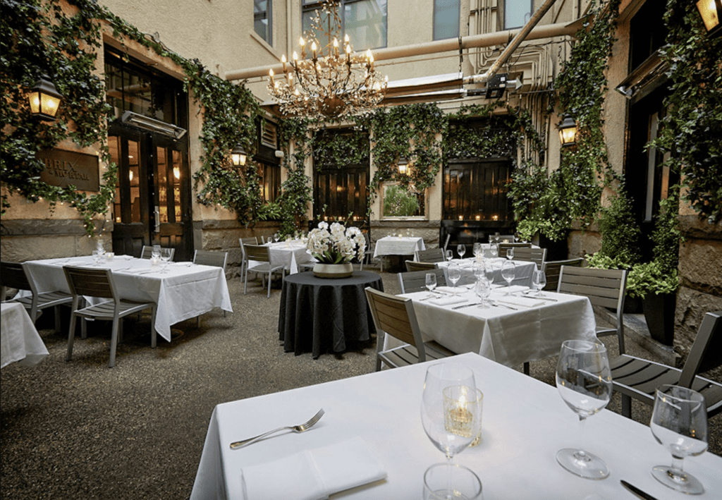 elegant courtyard restaurant in Vancouver, Brix & Mortar, set up with tables for a wedding