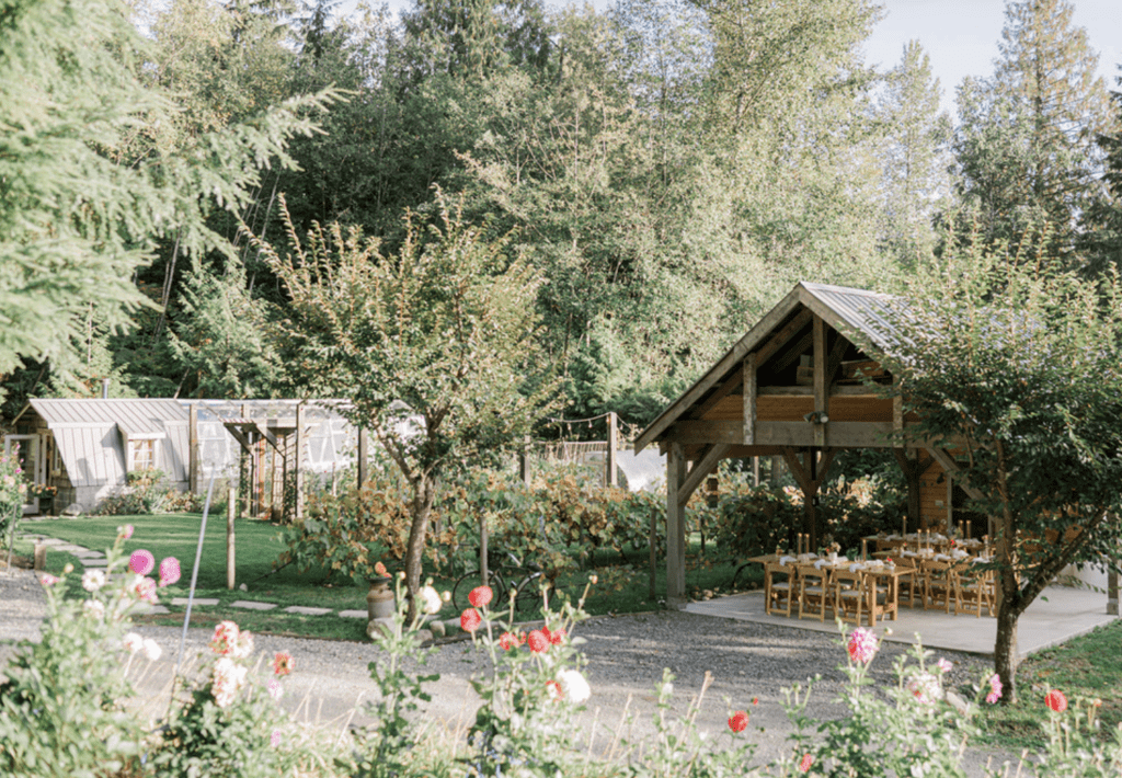sunny garden with a greenhouse and outdoor dining pavillion at Vanouver Intimate Wedding Venue